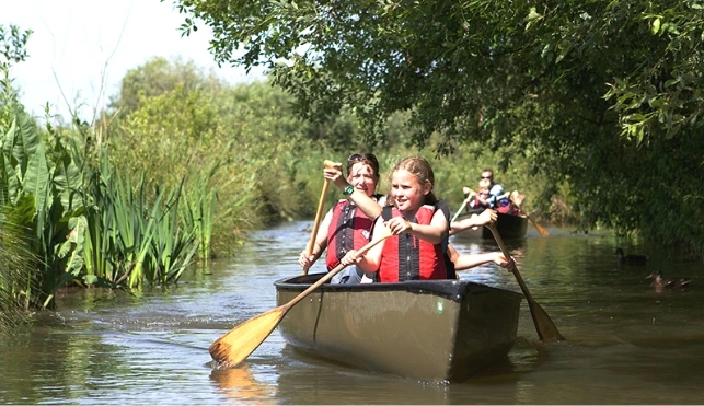 Family paddling a canoe at a WWT site